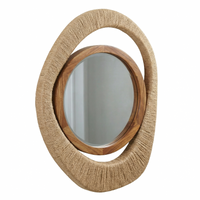Round mirror with woven brown frame on a white background